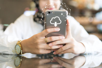 Midsection of woman using mobile phone