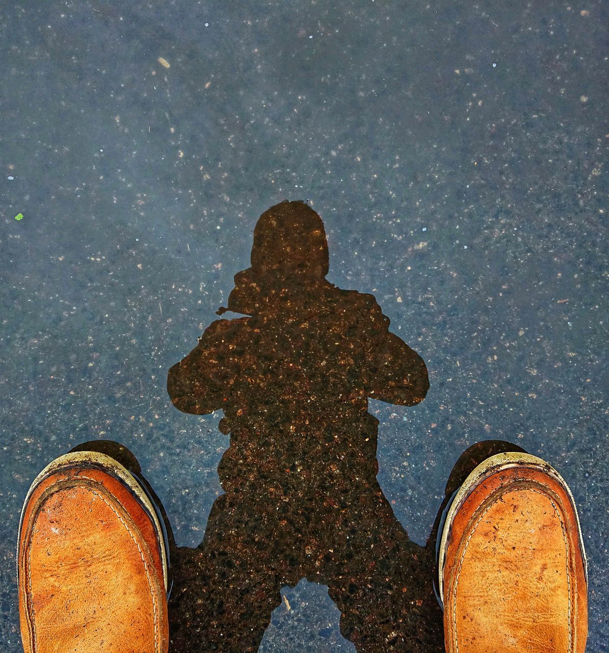 LOW SECTION OF PERSON STANDING ON WET METAL