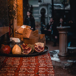 Fruits in basket on table against building