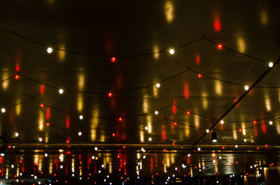 Low angle view of illuminated lights at night