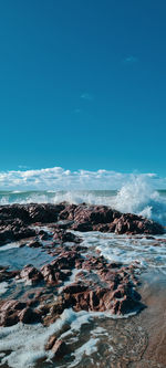 Scenic view of sea against blue sky