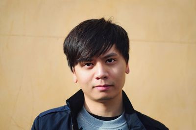 Portrait of young man against wall