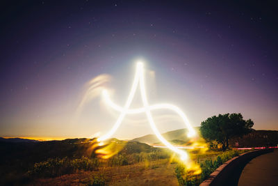 Light trails against sky at night