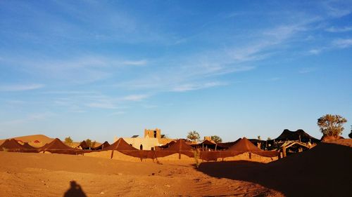 Panoramic view of desert against blue sky