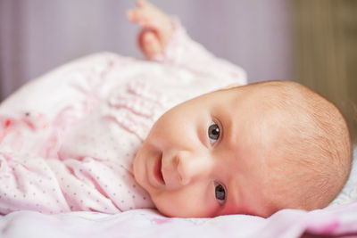 Close-up of cute baby boy sleeping on bed at home