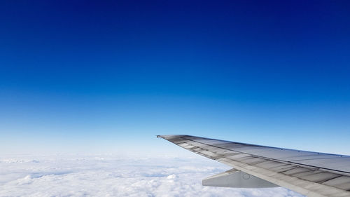 Airplane wing against blue sky