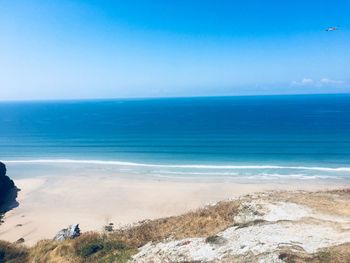 Scenic view of sea against blue sky