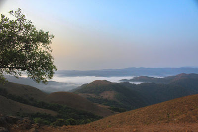 Scenic view of landscape and mountains against sky