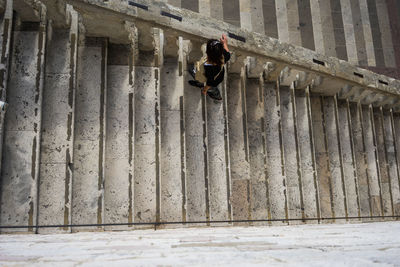 Rear view of man walking on building