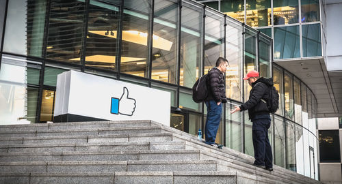 People walking on staircase of building