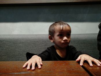 Portrait of boy on table