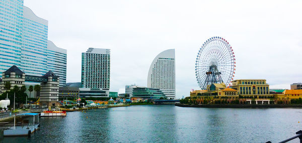 Ferris wheel in city against sky