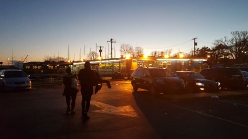View of road against clear sky at sunset