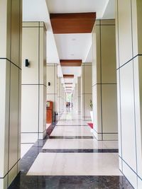 People walking in corridor of building