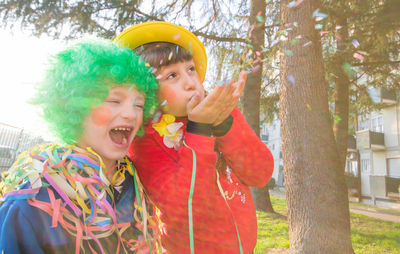 Children playing with confetti during event