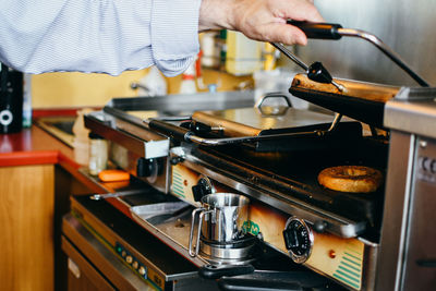 Midsection of man preparing food in kitchen