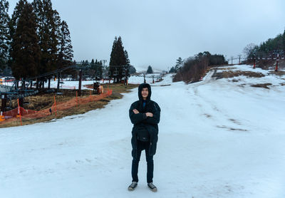 Portrait of man standing on snow