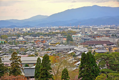 High angle view of townscape and mountains against sky