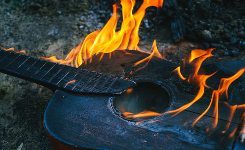 Shot of an acoustic guitar engulfed in strong flames