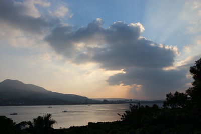 Scenic view of lake against cloudy sky