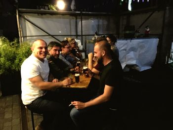 Young couple standing by drink at night