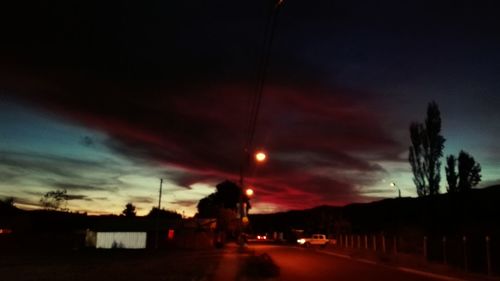 Cars on road at sunset