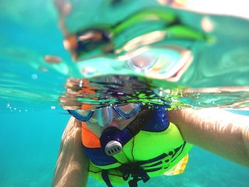 Man snorkeling undersea on sunny day