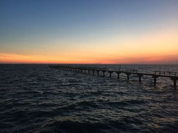 Scenic view of sea against clear sky during sunset