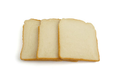 High angle view of bread and cake against white background