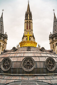 Low angle view of clock tower against building