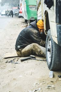 Sikh mechanic repairing truck