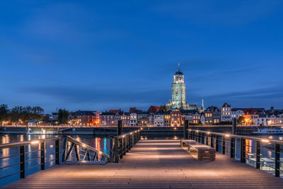 Illuminated buildings against sky at night