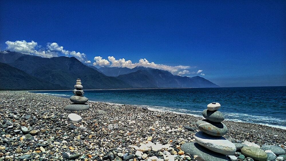 mountain, water, tranquility, tranquil scene, mountain range, scenics, rock - object, blue, beauty in nature, sky, sea, nature, lake, stone - object, idyllic, rock, day, calm, non-urban scene, remote