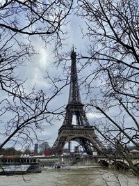 View of tower and bare tree against sky