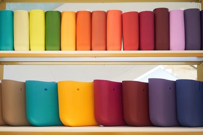 Close-up of colorful bags on shelves in store