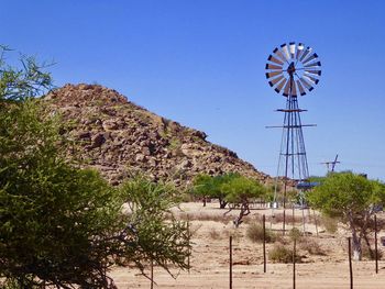 Traditional windmill against clear blue sky