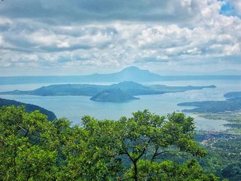 Scenic view of green landscape against sky