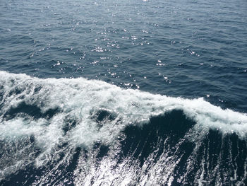 High angle view of waves splashing on sea