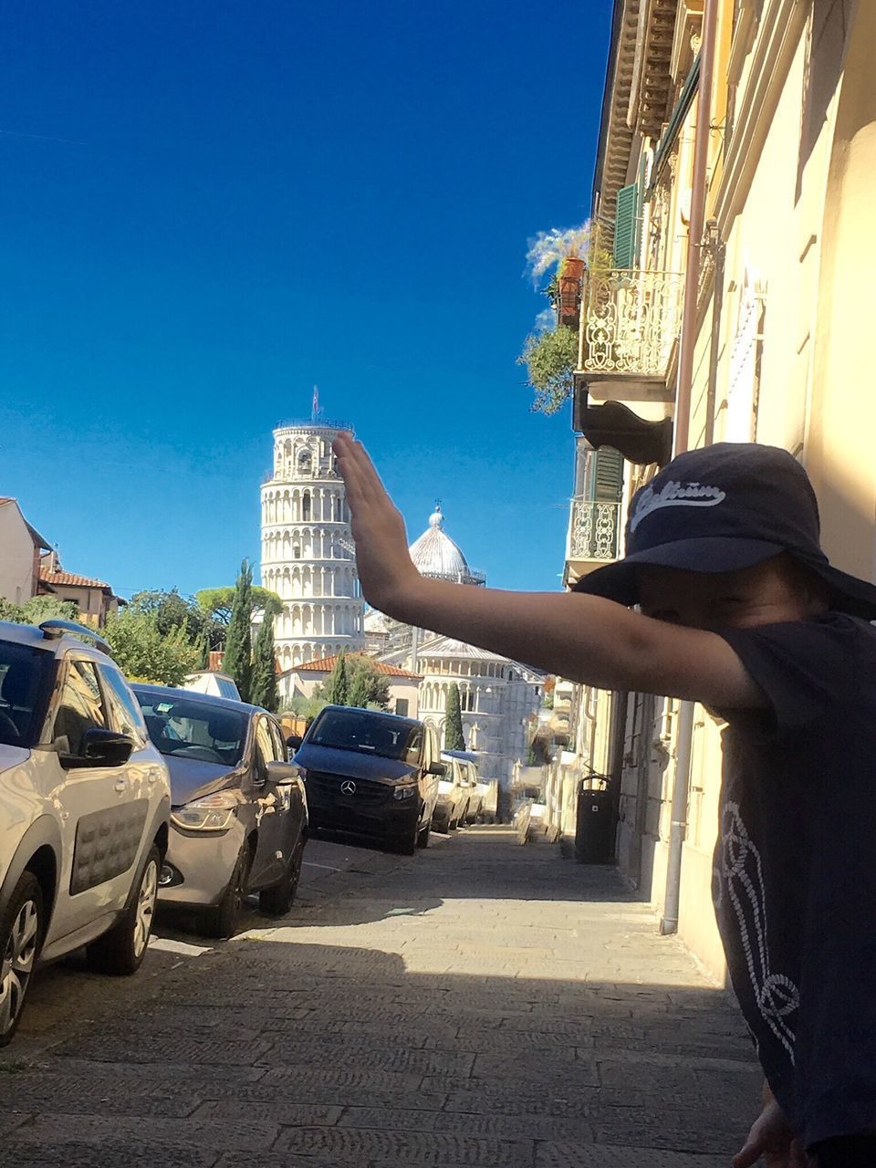 MAN ON CAR AGAINST BLUE SKY