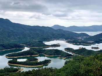 Scenic view of lake and mountains against sky