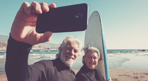 Portrait of man photographing on beach