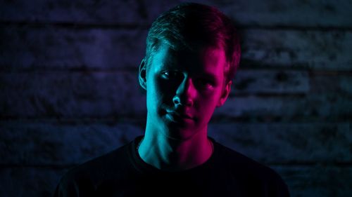 Portrait of young man against wall