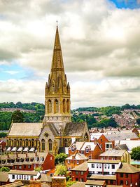 High angle view of clock tower against cloudy sky