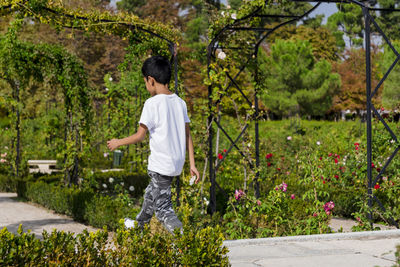 Young boy walking calmly in the park.