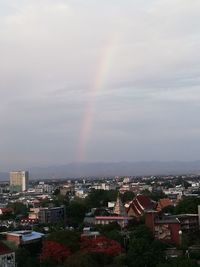 High angle view of rainbow over buildings in city