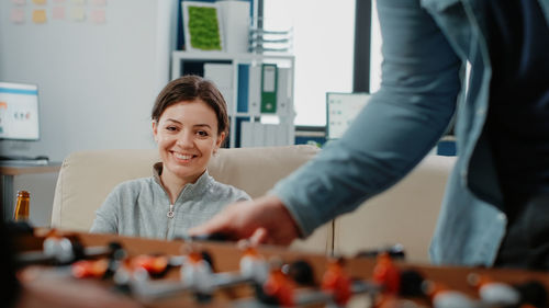 Portrait of smiling woman sitting on sofa