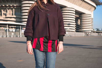 Midsection of woman standing in city