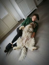 Woman with dog on carpet