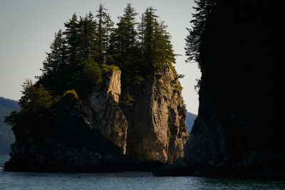 Rock formations in sea against sky
