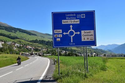 Road sign against clear blue sky